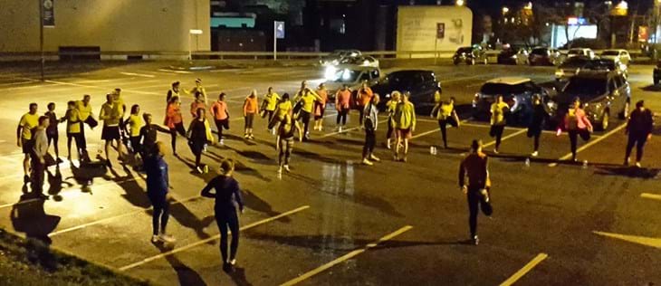 running group warm up in car park